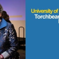 Photo of Barbara Nelson holding her Torchbearer Award at the ceremony