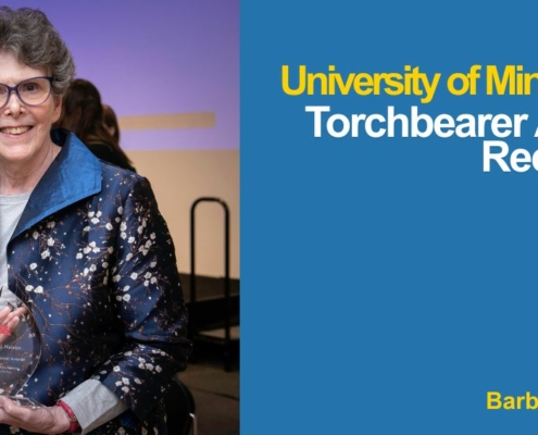 Photo of Barbara Nelson holding her Torchbearer Award at the ceremony