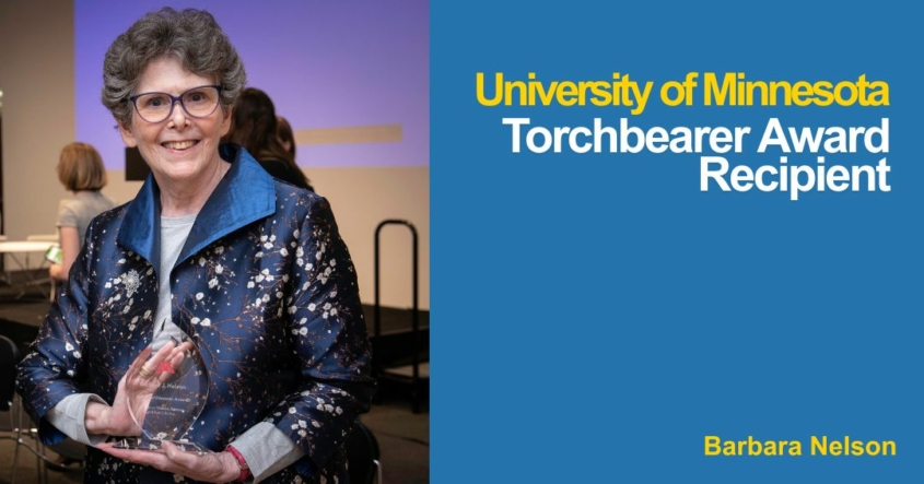 Photo of Barbara Nelson holding her Torchbearer Award at the ceremony