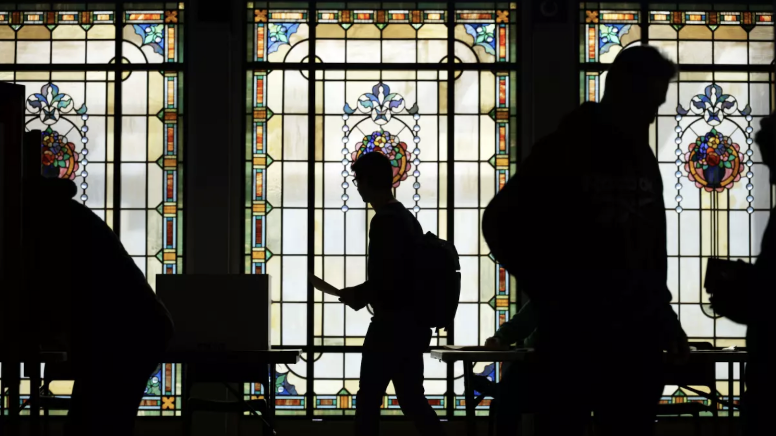 silhouette of voters against stained-glass background