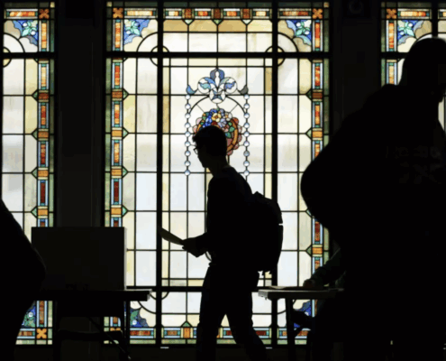 silhouette of voters against stained-glass background