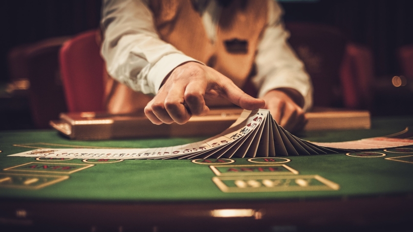 Croupier behind gambling table in a casino.