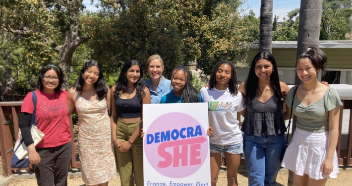 Group photo of Sarah Jakle at a DemocraShe event.