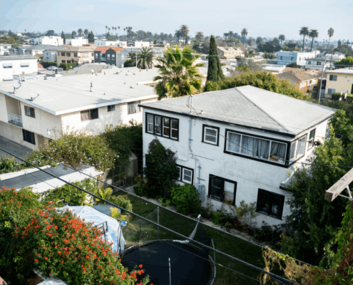 An aerial shot of a Los Angeles neighborhood, photo of a white apartment building.