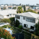An aerial shot of a Los Angeles neighborhood, photo of a white apartment building.