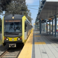 UCLA ITS A yellow metro train at a station.