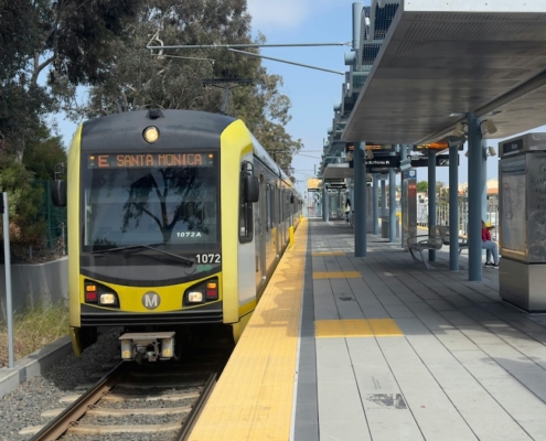 A yellow metro train at a station.