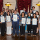 Luskin students hold up their certificates in a group photo on City Hall at Luskin.