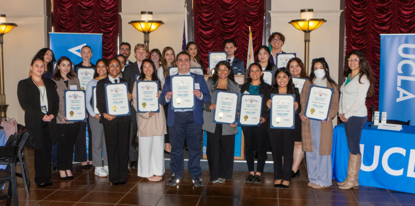 Luskin students hold up their certificates in a group photo on City Hall at Luskin.