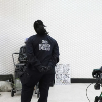 Civilian officers in black jackets in transit station