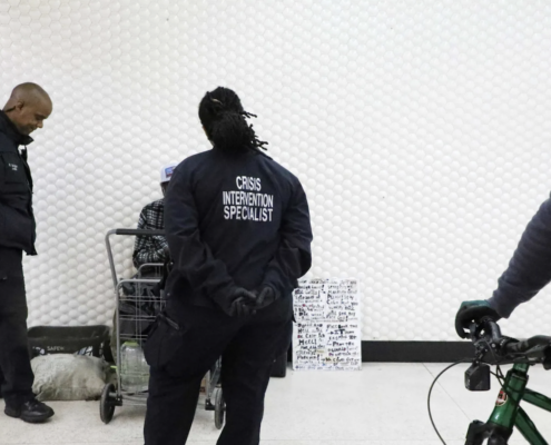 Civilian officers in black jackets in transit station