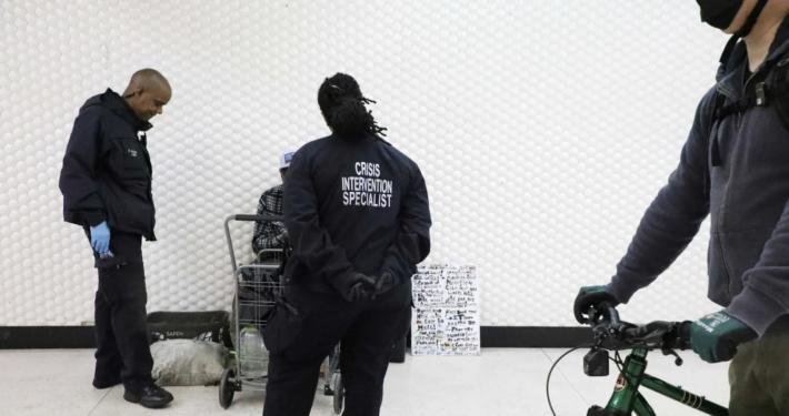 Civilian officers in black jackets in transit station