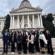Group of people in front of ornate white building