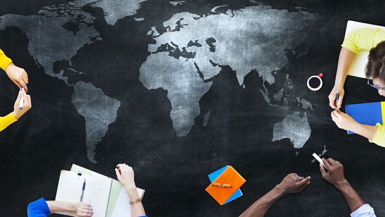 people studying around map of world