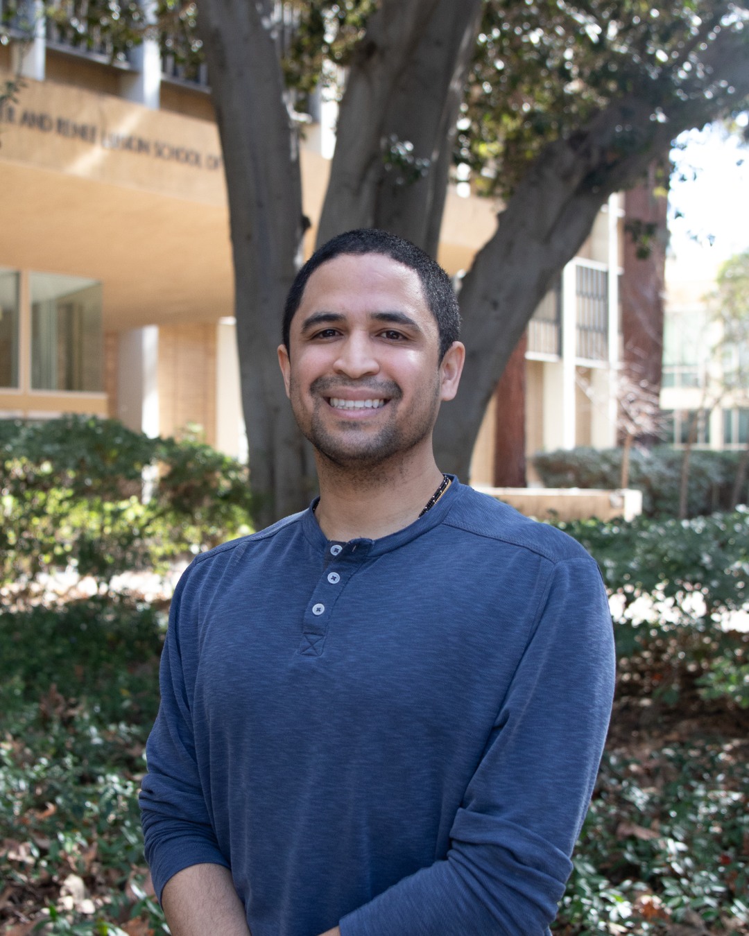 Headshot of social welfare phd student Juan Nunez in front of the public affairs building