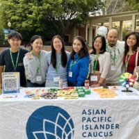 Negin Dadmarz at a table for the Asian Pacific Islander Caucus.