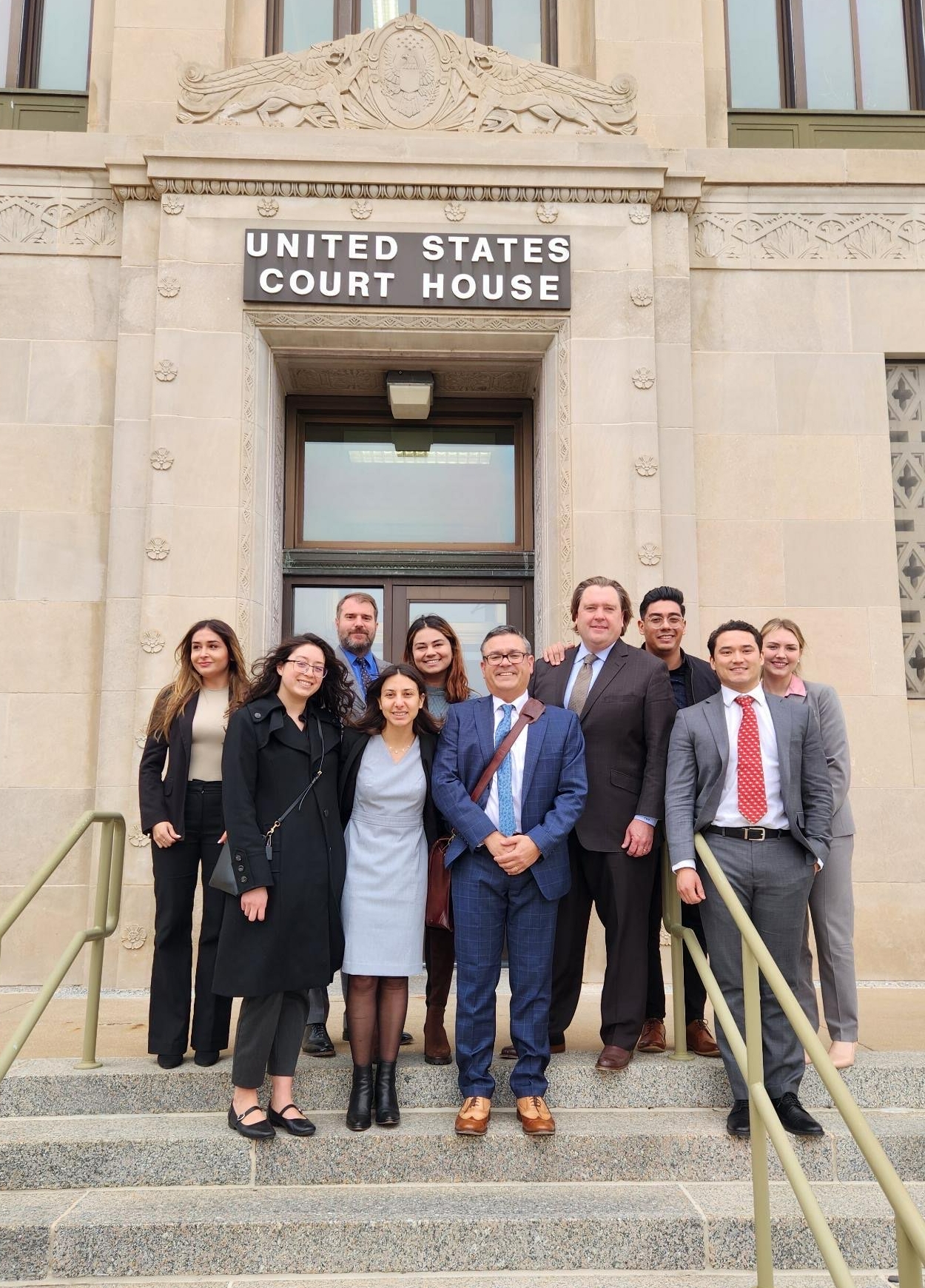Voting Rights Project team stands in front of the States of United States Court House
