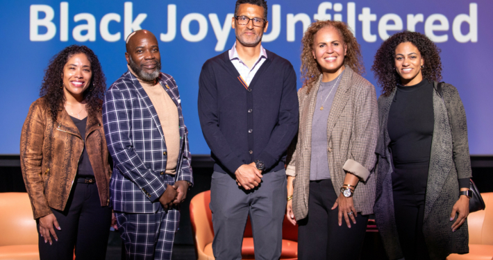 Panelists from the Luskin Lecture on February 25 at the UCLA Nimoy Theater with Michael Harriot, Michael Lens, and Safiya Noble stand on center stage to pose for a group photo.