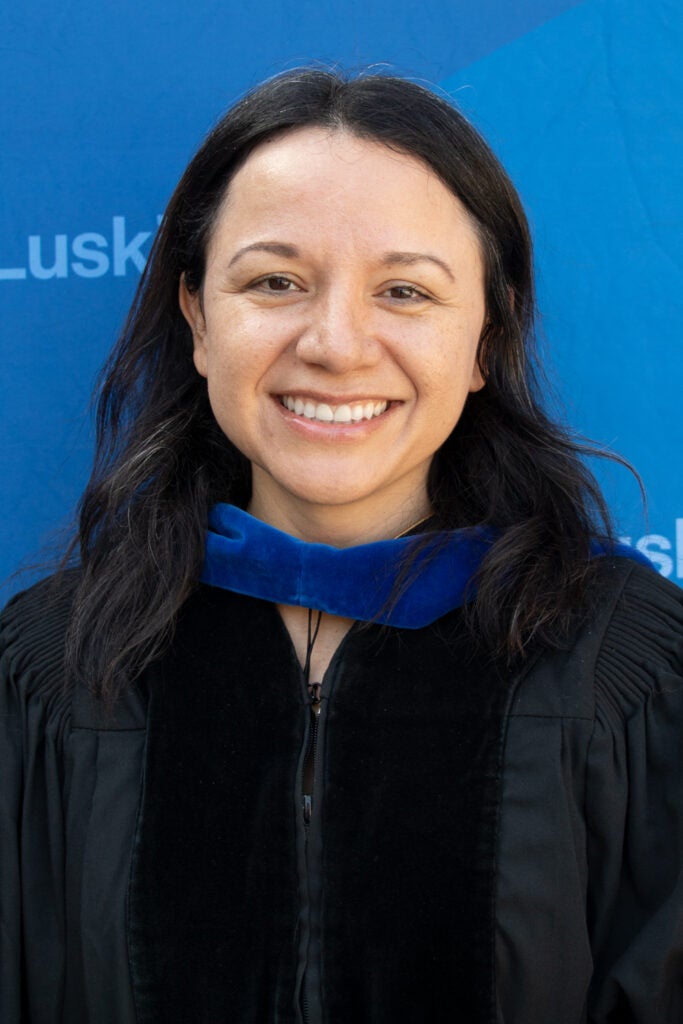 |woman in commencement cap and gown|woman in commencement cap and gown