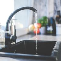 Kitchen faucet running water.