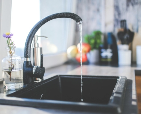 Kitchen faucet running water.