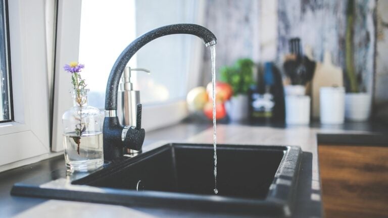 Kitchen faucet running water.