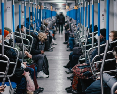People sitting inside a metro train.