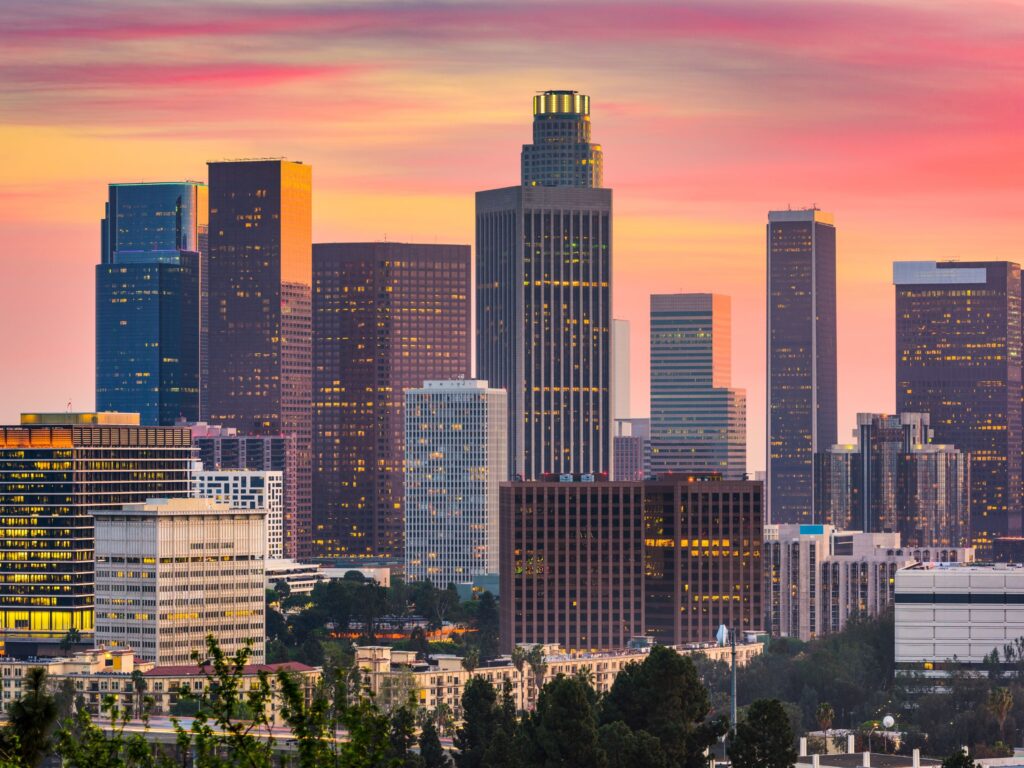 Los Angeles Downtown skyscrapers and cityscape against a sunset orange sky.