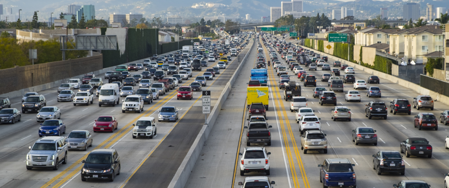 A northbound view of the 405 freeway during Friday afternoon traffic with Getty Museum, Westwood and Santa Monica mountains in the background.