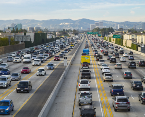 A northbound view of the 405 freeway during Friday afternoon traffic with Getty Museum, Westwood and Santa Monica mountains in the background.