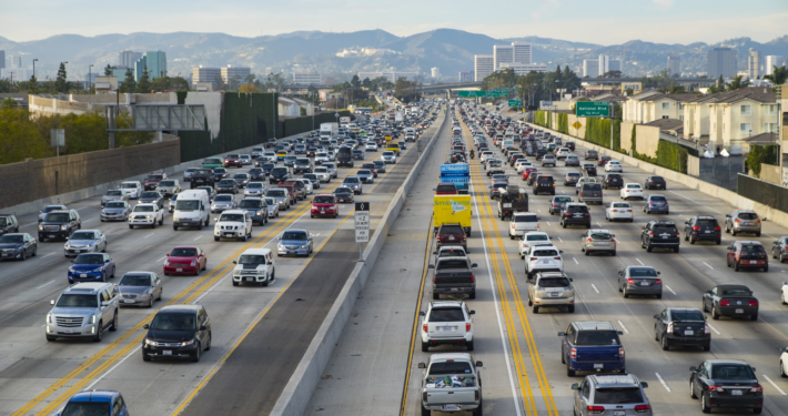 A northbound view of the 405 freeway during Friday afternoon traffic with Getty Museum, Westwood and Santa Monica mountains in the background.