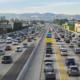 A northbound view of the 405 freeway during Friday afternoon traffic with Getty Museum, Westwood and Santa Monica mountains in the background.