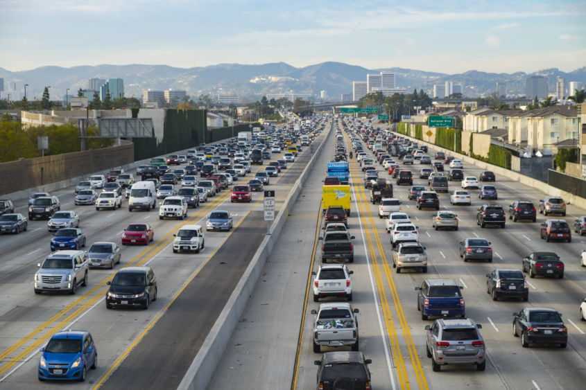 A northbound view of the 405 freeway during Friday afternoon traffic with Getty Museum, Westwood and Santa Monica mountains in the background.