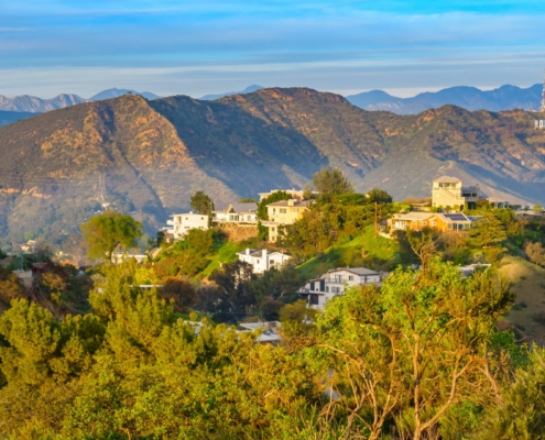 hollywood hills with homes and mansions, mountains in the background and the Hollywood sign