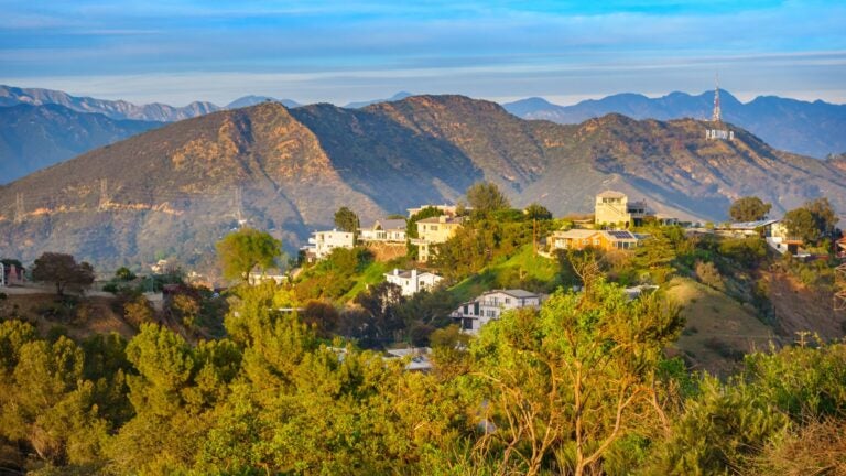 hollywood hills with homes and mansions, mountains in the background and the Hollywood sign