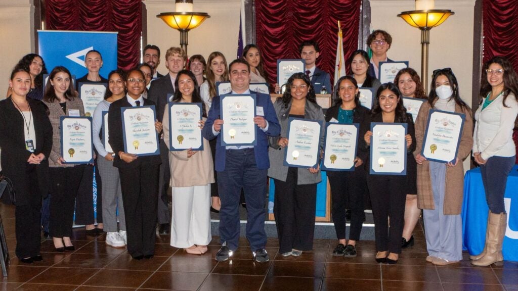 Luskin Students stand together for a group photo with their certificate of awards on the annual Luskin City Hall Day 2026.|Headshot of O'philia Le masters in urban planning student|MURP student O'philia Le at City Hall Day