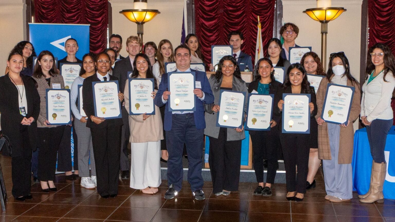Luskin Students stand together for a group photo with their certificate of awards on the annual Luskin City Hall Day 2026.|Headshot of O'philia Le masters in urban planning student|MURP student O'philia Le at City Hall Day