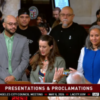Los Angeles City Council Meeting on May 8, a speaker presents José Loya and Amada Armenta with their "impactful chicanos" award at City Hall.