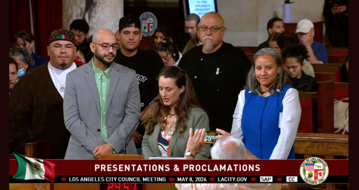 Los Angeles City Council Meeting on May 8, a speaker presents José Loya and Amada Armenta with their "impactful chicanos" award at City Hall.