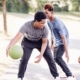 three boys are playing basketball