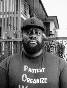 Person with beard wearing cap