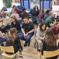 Visiting educators sit in concentric circles for one-on-one conversations