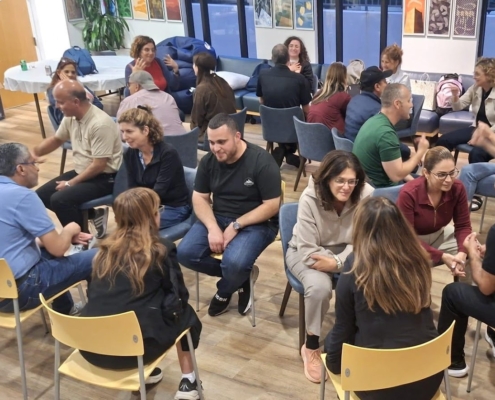 Visiting educators sit in concentric circles for one-on-one conversations