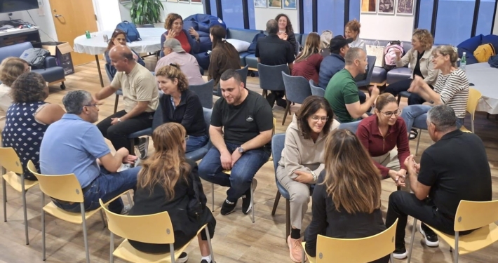 Visiting educators sit in concentric circles for one-on-one conversations