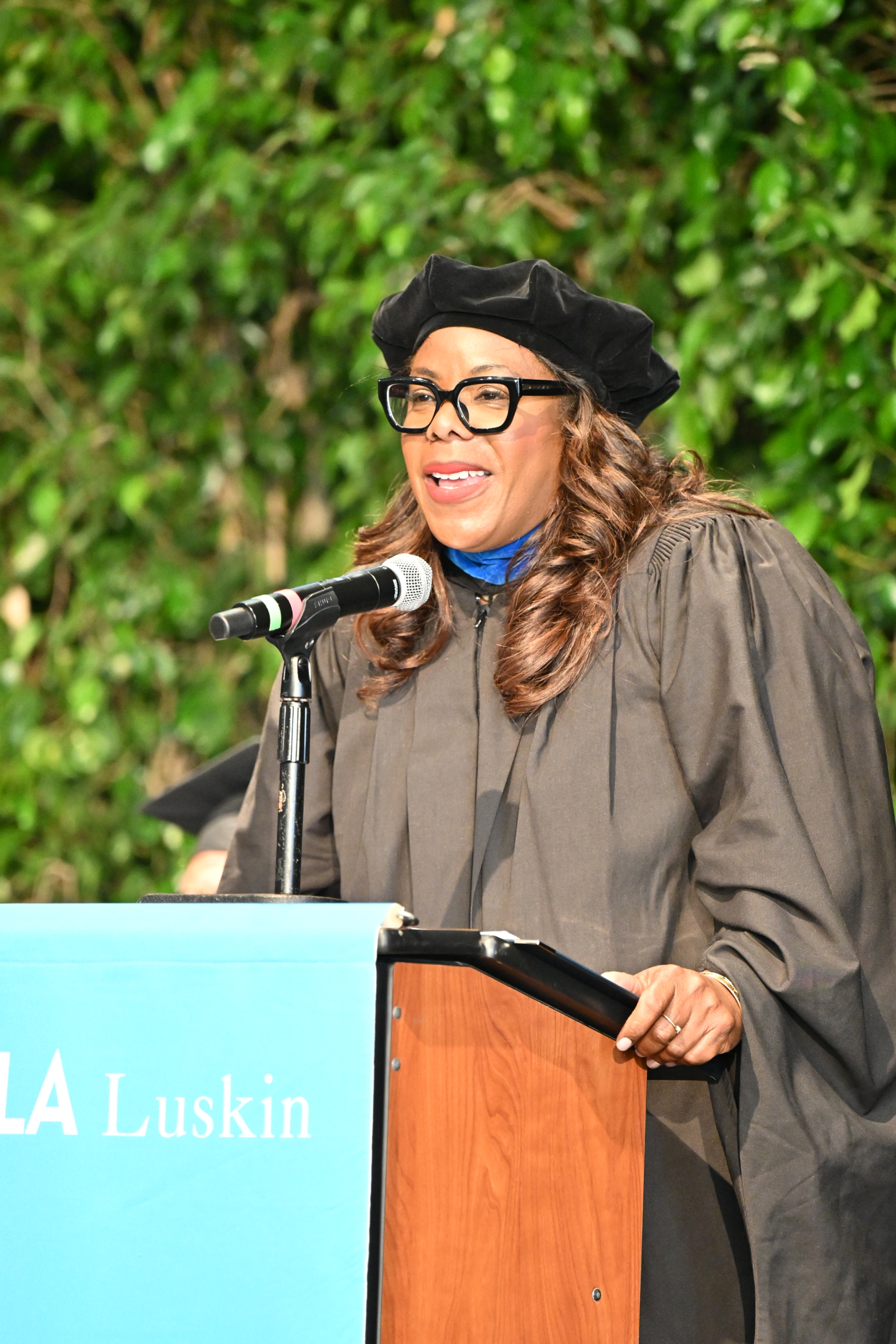 Jacqueline Waggoner '18 on the stage in front of a podium giving her commencement speech to the undergraduate class of 2026.