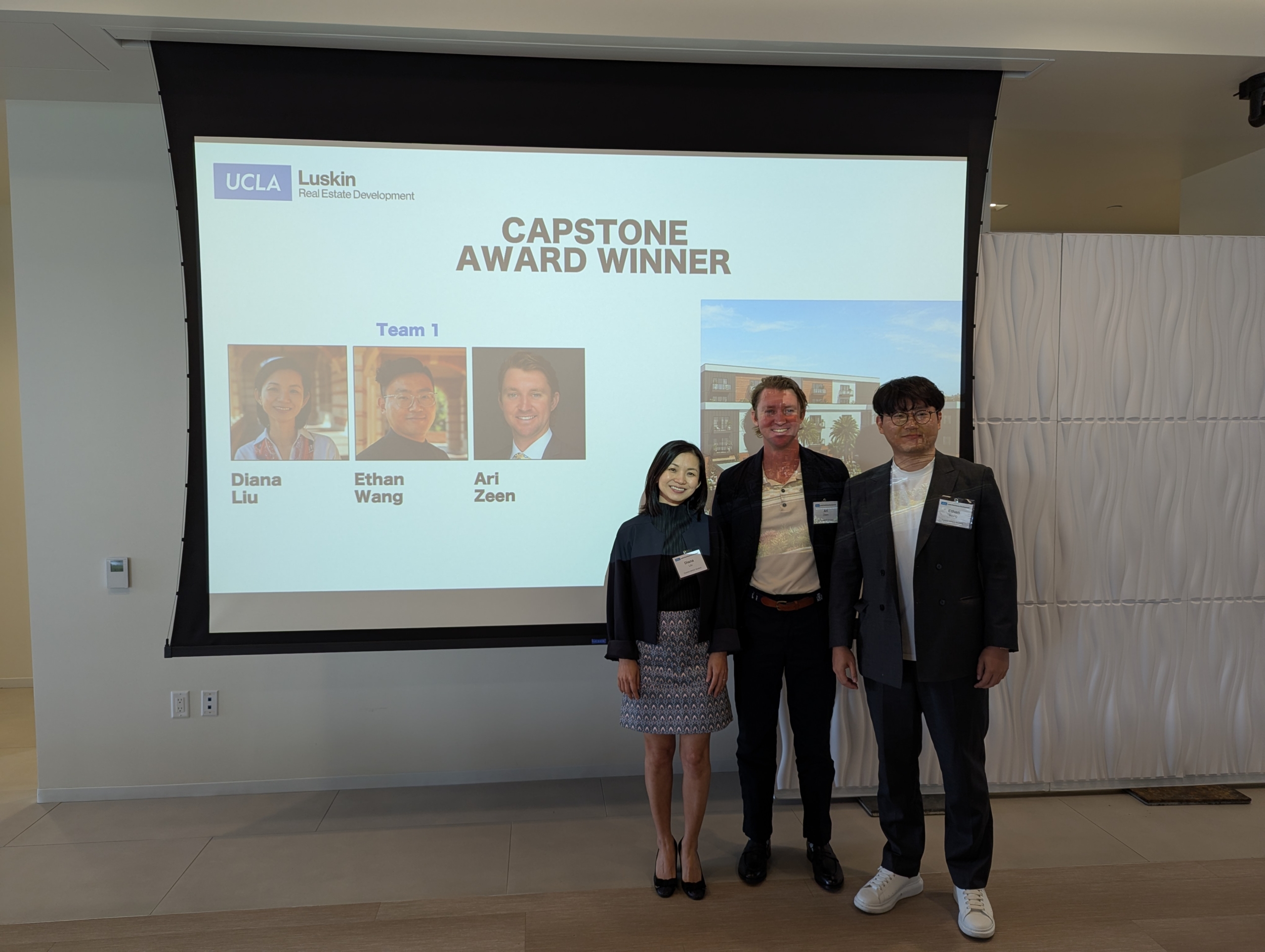 Capstone winnders Diana Liu, Ari Zeen and Ethan Wang stand together in front of their presentation.