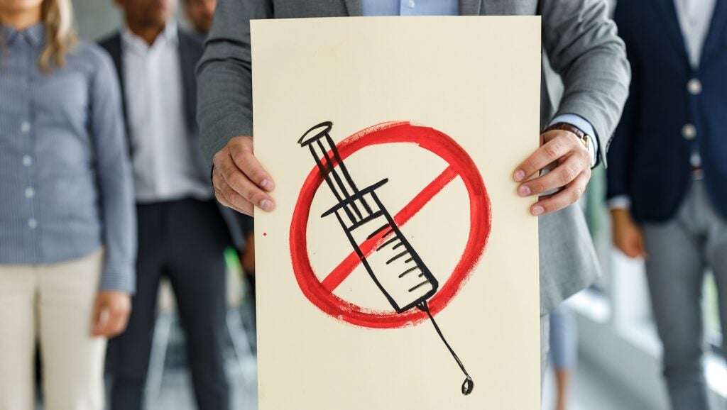 Protester holds anti-vaccine poster