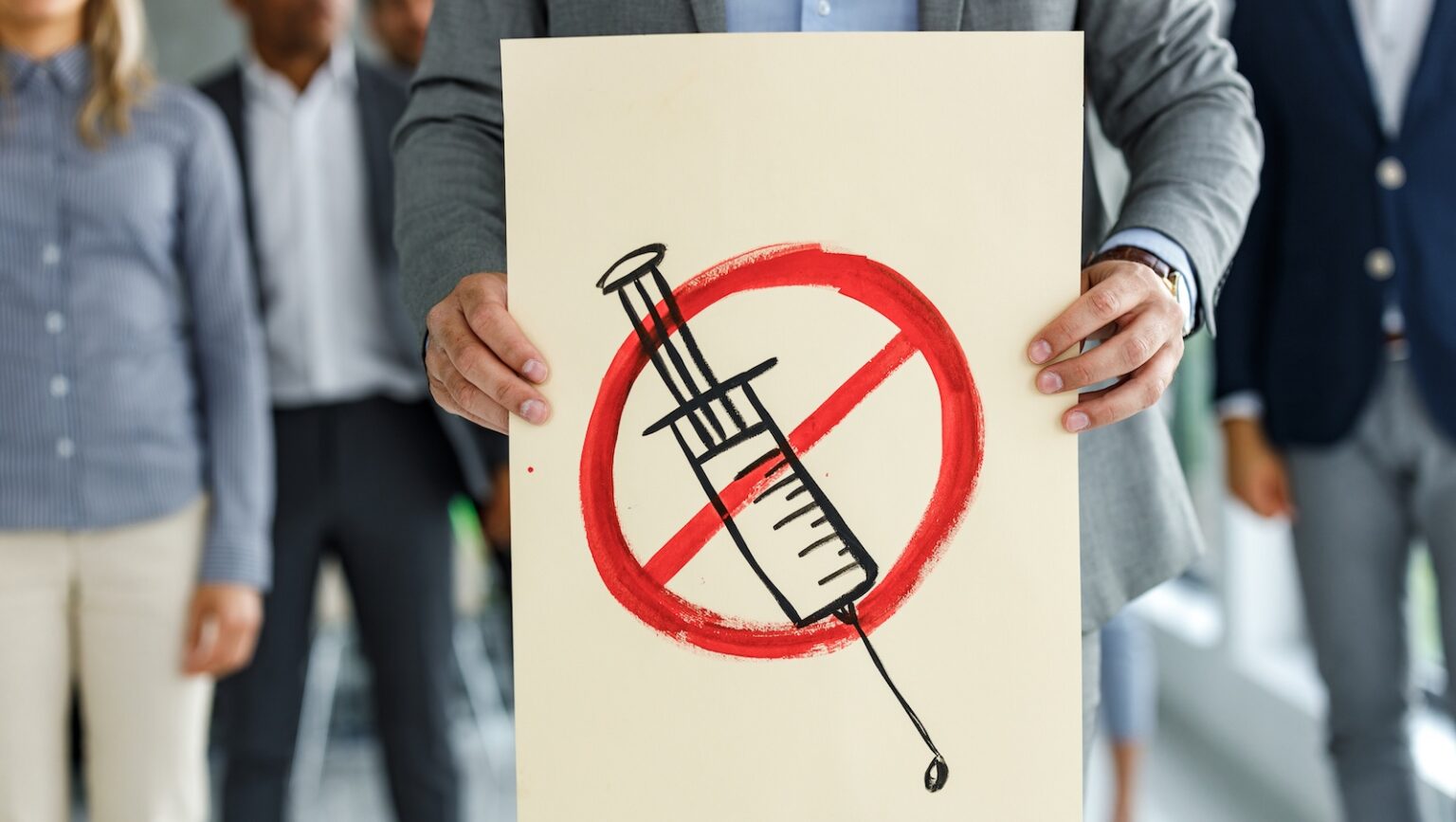 Protester holds anti-vaccine poster
