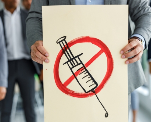 Protester holds anti-vaccine poster
