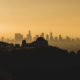 silhouette of Griffith Observatory set again orange sky and Los Angeles skyline